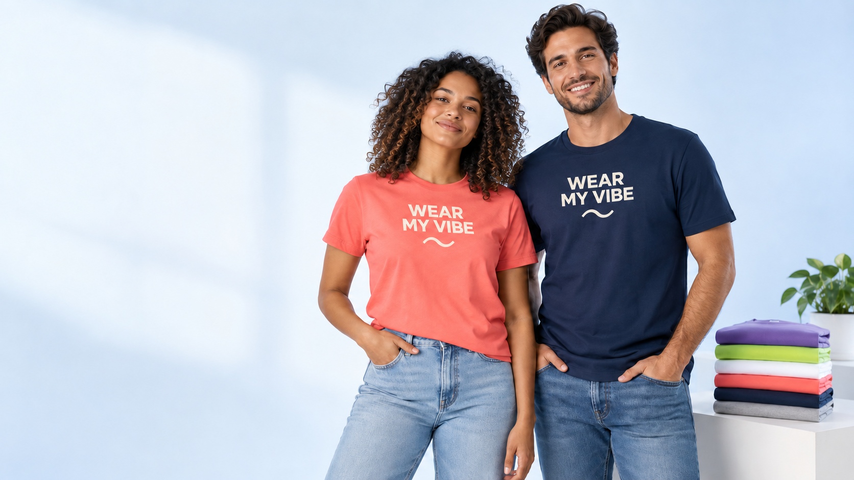 Woman and man modeling coral and navy T-shirts with Wear My Vibe chest designs